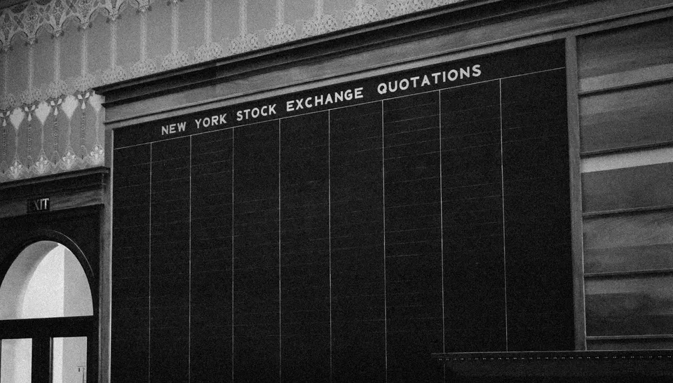 Empty New York Stock Exchange quotations chalkboard.